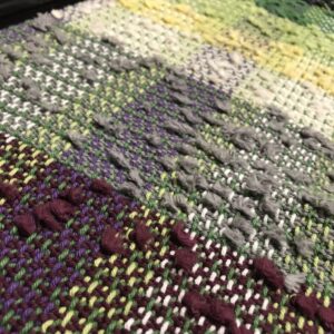 Handwoven fabric using yarn waste